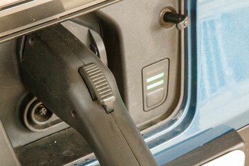 Close-up of an electric vehicle charging port.