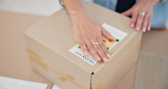 Online order, label sticker and woman hand with small business in fashion with delivery and cardboard box. Stock, startup and sales of ecommerce and boutique at home of a entrepreneur with package
