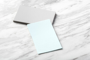 Pastel blue and grey business card mockup on white marble background
