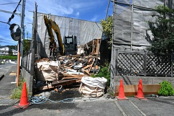 A scene of house demolition work. Architectural related construction site background material.