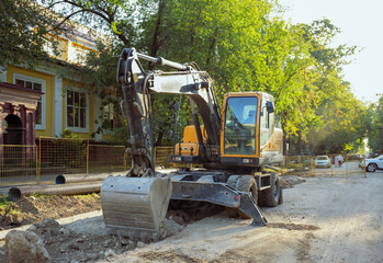 The excavator bucket is lowered into the ground