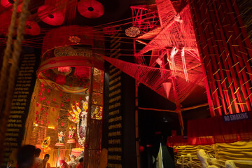 Beautifully decorated Durga idol is being worshipped inside puja pandal.