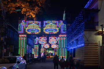 Decorated and illuminated street during Durga puja festival night.