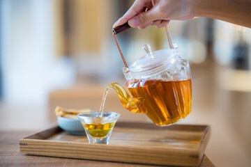 Pour tea into glass of water