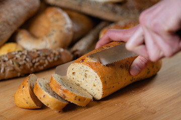 Close-up captures the delicate precision of slicing bread