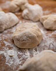 Fototapeta na wymiar balls of dough on wooden countertop
