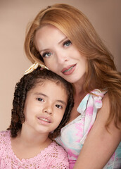A heartwarming portrait of a Hispanic mother and her young daughter in casual attire, sharing love, laughter, and family bonds against a Tuscany color background.