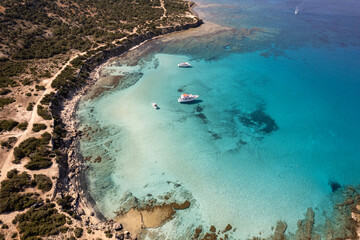 Aerial view of blue lagoon beach in Cyprus island, Paphos national park. Crystal clear water with some tourist boats floating. Akamas National Forest Park