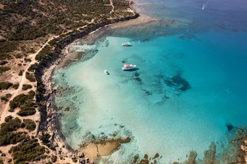 Papier Peint photo autocollant Chypre Aerial view of blue lagoon beach in Cyprus island, Paphos national park. Crystal clear water with some tourist boats floating. Akamas National Forest Park