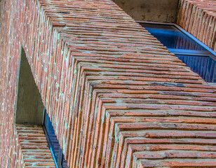Angled view on modern red clinker brick facade wall of residential building house