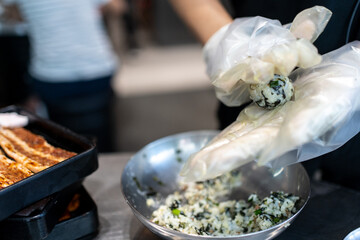 Hands making Korean seaweed rice ball called in Korean is Jumeogbab, jumeokbap, Onigiri or Chu Mok Bab is famous traditional Korean food. Seaweed rice ball mixed with seaweed, sesame seed, vegetable. - 641953194