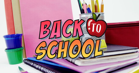 Image of back to school text over school items