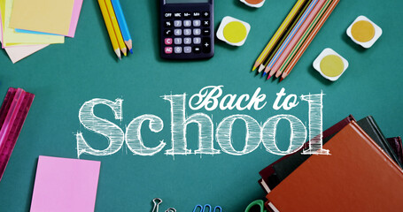 Image of back to school text over school items