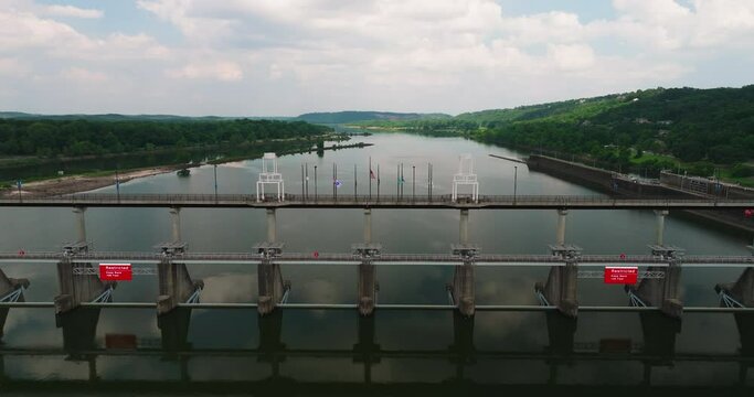 Fly Over Big Dam Bridge Gates Over Arkansas River In Cook's Landing Park, North Little Rock, Arkansas USA. Aerial Shot