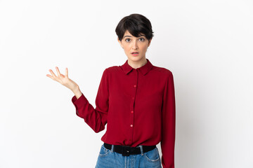 Woman with short hair isolated on white background making doubts gesture
