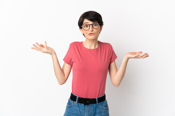 Woman with short hair isolated on white background having doubts while raising hands