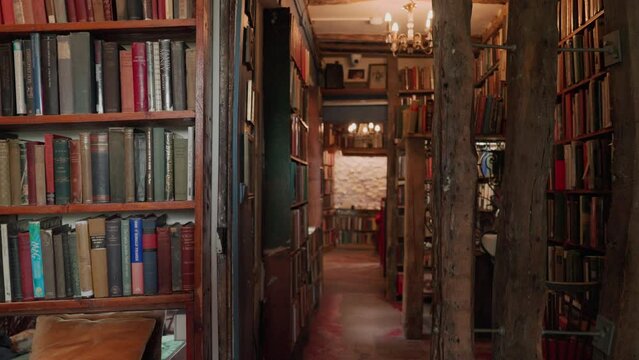 Corridor between shelves in an old bookstore in Paris