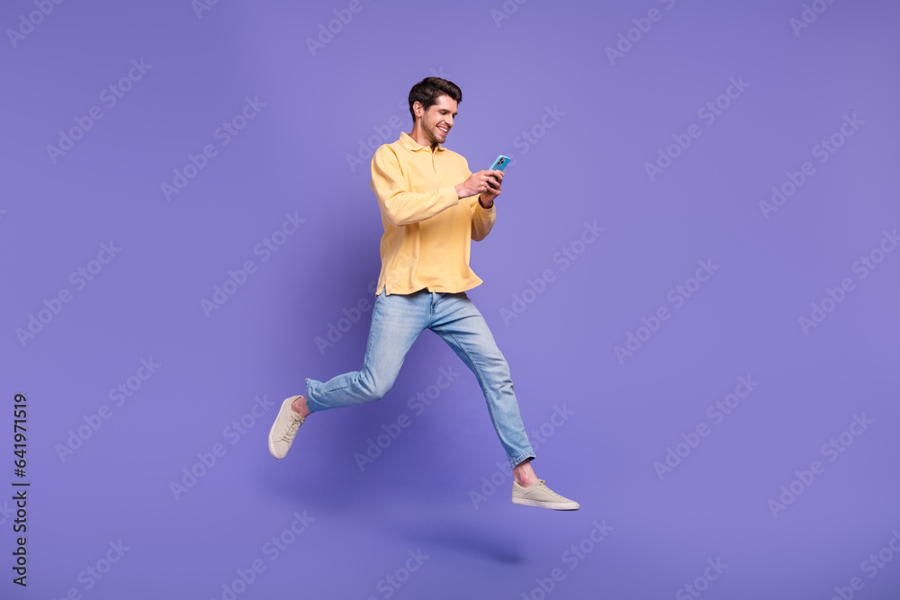 Poster full length size body photo of jumping funky guy browsing new modern smartphone social media markete