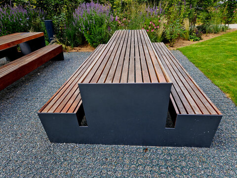 installation of a plastic mat as a substitute for lawn. plastic permeable tiles are filled with a fine putty. under the benches is a reinforced grass paving, flowerbed, rest, terrace