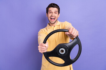 Fototapeta na wymiar Portrait of overjoyed nice person have good mood hands hold steering wheel isolated on purple color background