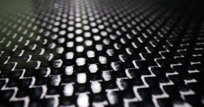 Water repellent black fabric pattern as background. Fabric protector concept designed to repel liquids. Hydrophobic water with black background macro