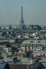 view of the Eiffel tower walking through Paris