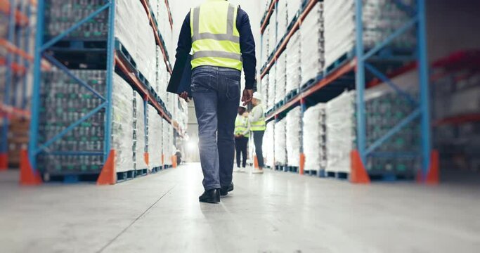 Legs, walking and engineer man in warehouse for shipping, distribution or inventory. Employee, worker and technician in factory to check supply chain stock, logistics or storage of industrial cargo