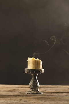 Fototapeta Vertical image of extinguished candle with copy space on grey background