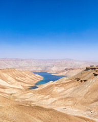 Band-e-Amir Lake and National Park in Afghanistan. High mineral content makes the lake intensely blue and thus popular tourist attraction. A hardened mineral travertine surrounds the lake.