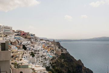 Fototapeta na wymiar Picturesque view of Santorini, Oia, Greece. Medieval historic blue and white buildings and seaside view. Traditional European, Greek architecture. Summer holidays travel