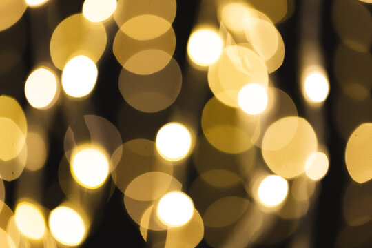 Multiple yellow bokeh lights with copy space on dark background