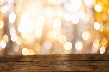 Shining curtain and yellow bokeh blurred lights with copy space and wooden surface