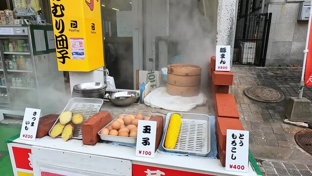 MArket stand in Japan. Cooking eggs and sweet potaoes in the boilling heat of a volcano in Beppu, Oita, Kyushu, Japan. Steaming volcanic lake called Jigoku