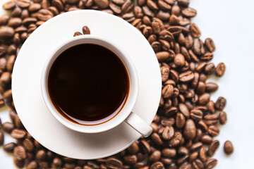 Top view of black coffee in isolated cup with coffee beans