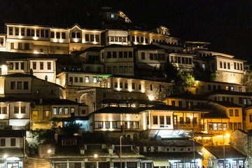 Fototapeta na wymiar Detail of houses in the illuminated historic town of Berat in Albania, UNESCO, the city of a thousand windows