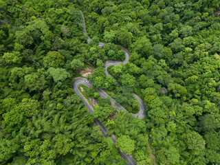 Aerial view road in the middle forest, Top view road going through green forest adventure,...