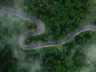 Aerial view road in the middle forest, Top view road going through green forest adventure, Ecosystem ecology healthy environment road trip travel net zero