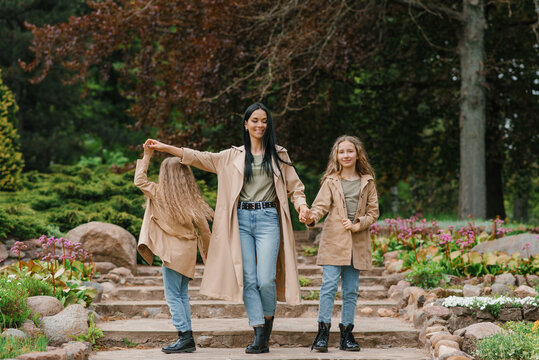 Caucasian Stylish Family In The Same Clothes Have Fun In The Spring In The Park