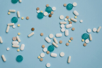 Various medications in tablets and wholesale on a blue background. Medical concept.