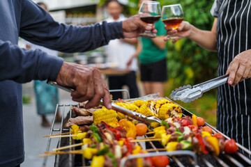 barbecue party with a happy family on weekends - obrazy, fototapety, plakaty