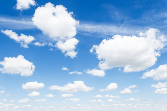 Cumulus clouds in blue sky, white fluffy clouds floating in blue sky, blue sky background with clouds