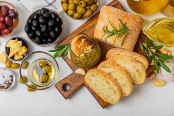 Ciabatta and olives. Fresh italian ciabatta bread with herbs, olive oil,parmesan and pesto sauce, olives on wooden background, top view, copy space.Flatley. Place for text. copy space.