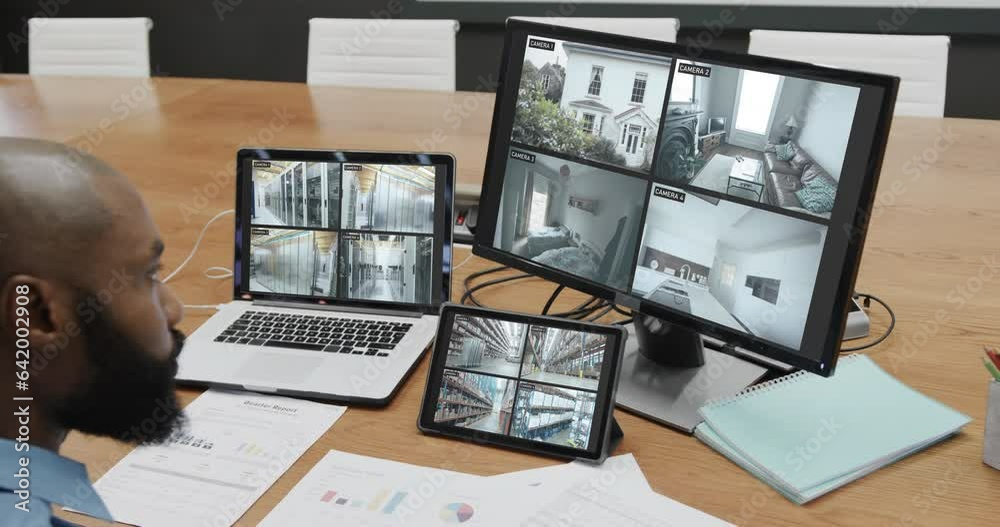 Poster African american male security officer watching cctv camera views on three screens, slow motion