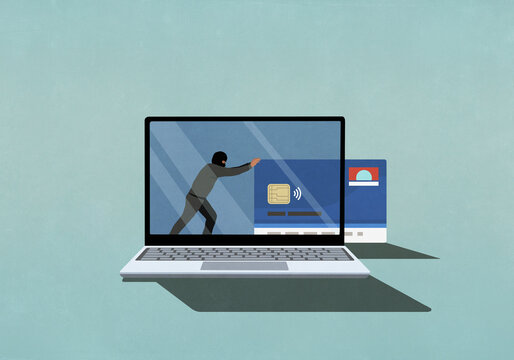 Computer hacker pushing credit card off laptop screen
