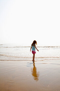Young girl playing on a beach
