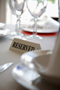 Extreme close up of tableware and reserved sign
