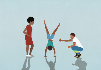 Supportive parents cheering for son doing handstand
