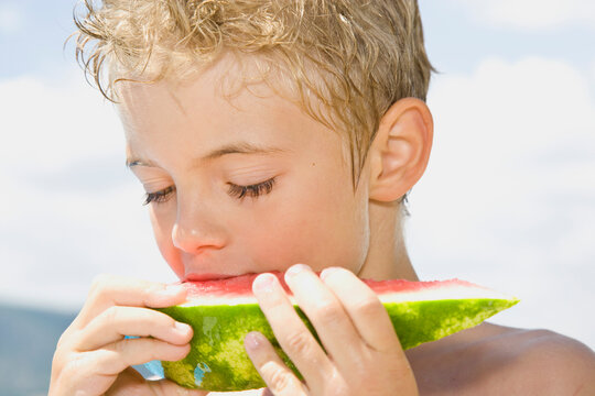 Young boy eating water melon
