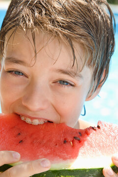 Young boy eating water melon
