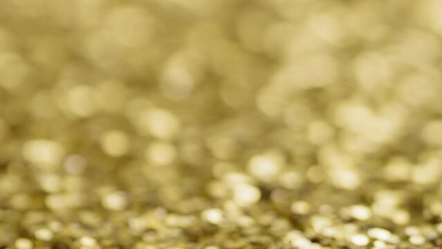Gold sequins with blurred background, establishing background shot